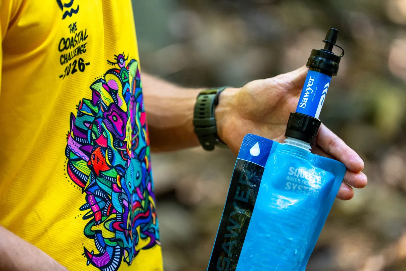 Sawyer squeeze water filter in a runner's hand
